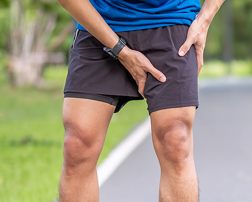 A man clutching his groin with joint pain